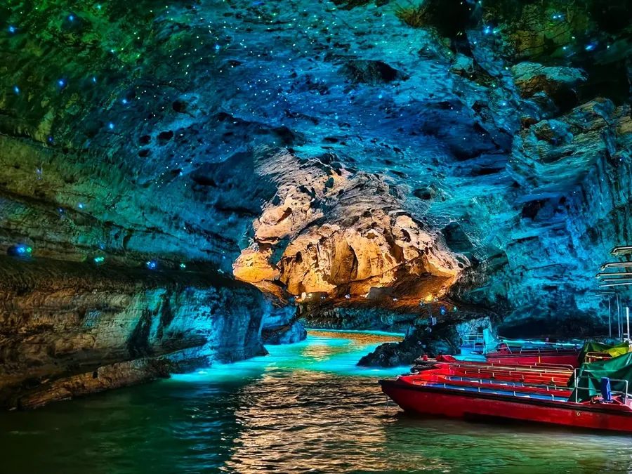 Illuminated stalactites and the Dragon Pillar inside Yellow Dragon Cave