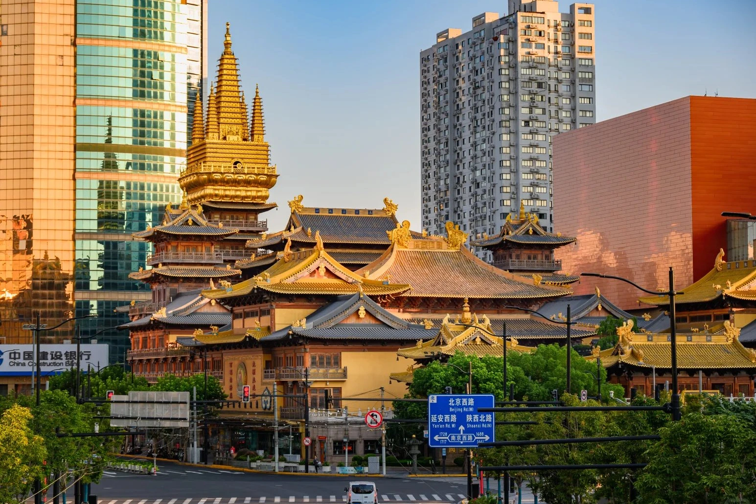 Jing'an Temple golden pagoda rising between modern skyscrapers — 1,700-year-old Buddhist temple in downtown Shanghai