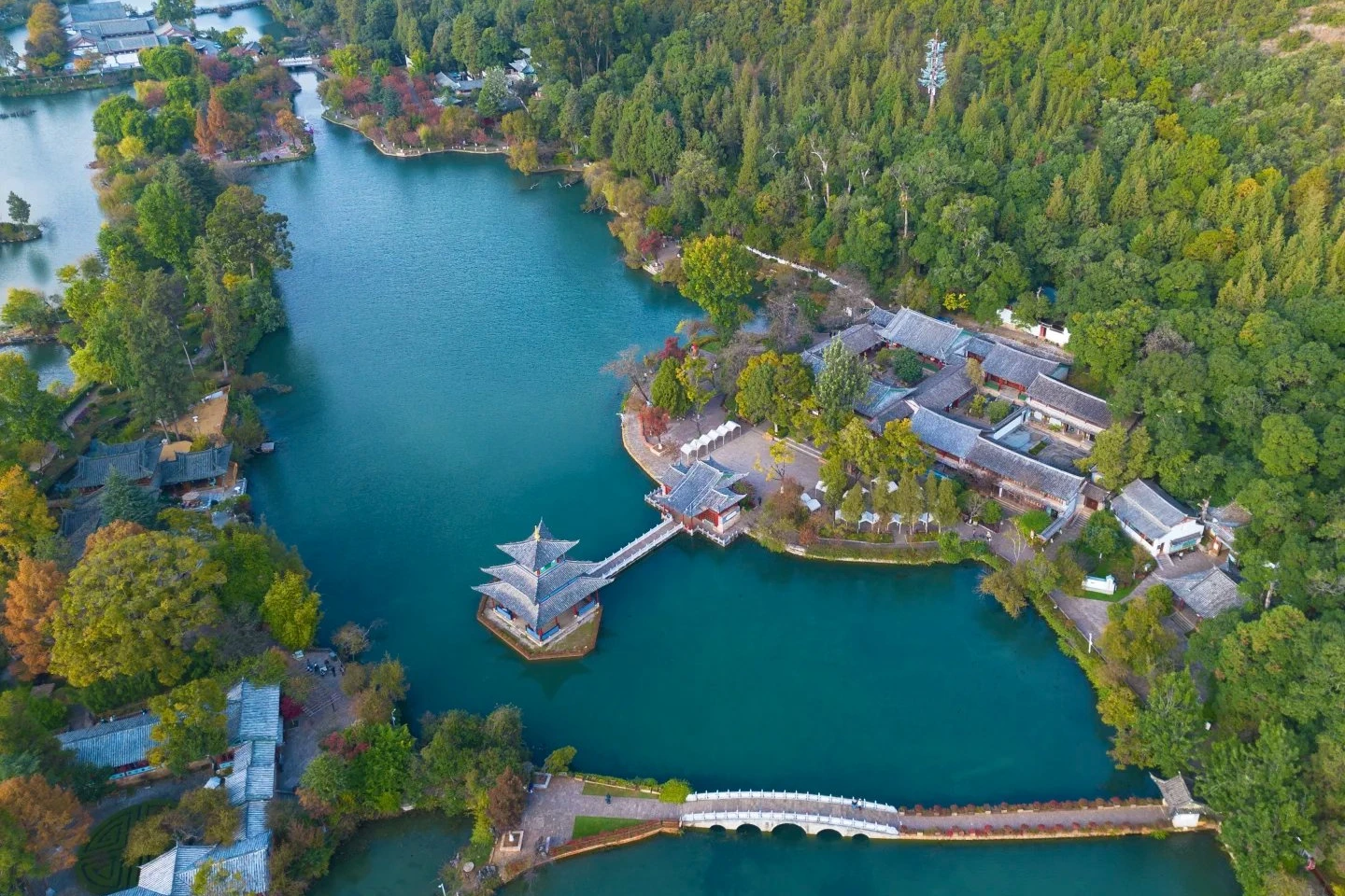 Black Dragon Pool Park with traditional pavilion reflected in still water surrounded by trees