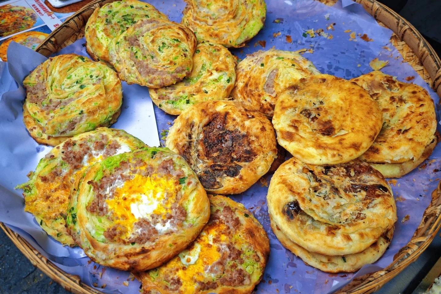 Freshly baked Xizhou baba flatbreads in a basket at the local market