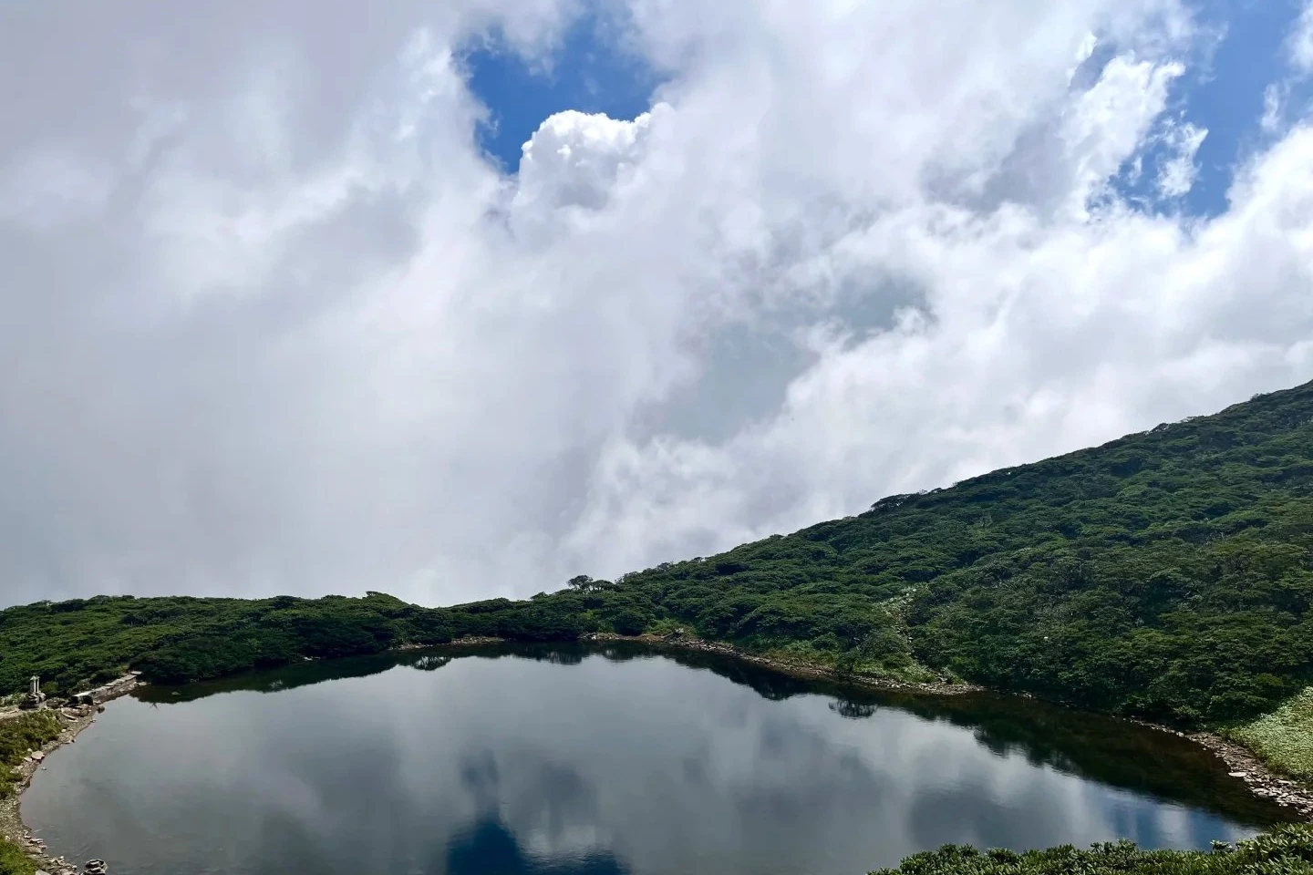 Ximatan alpine lake at 3,966 m on Cangshan — the summit pool surrounded by cloud forest