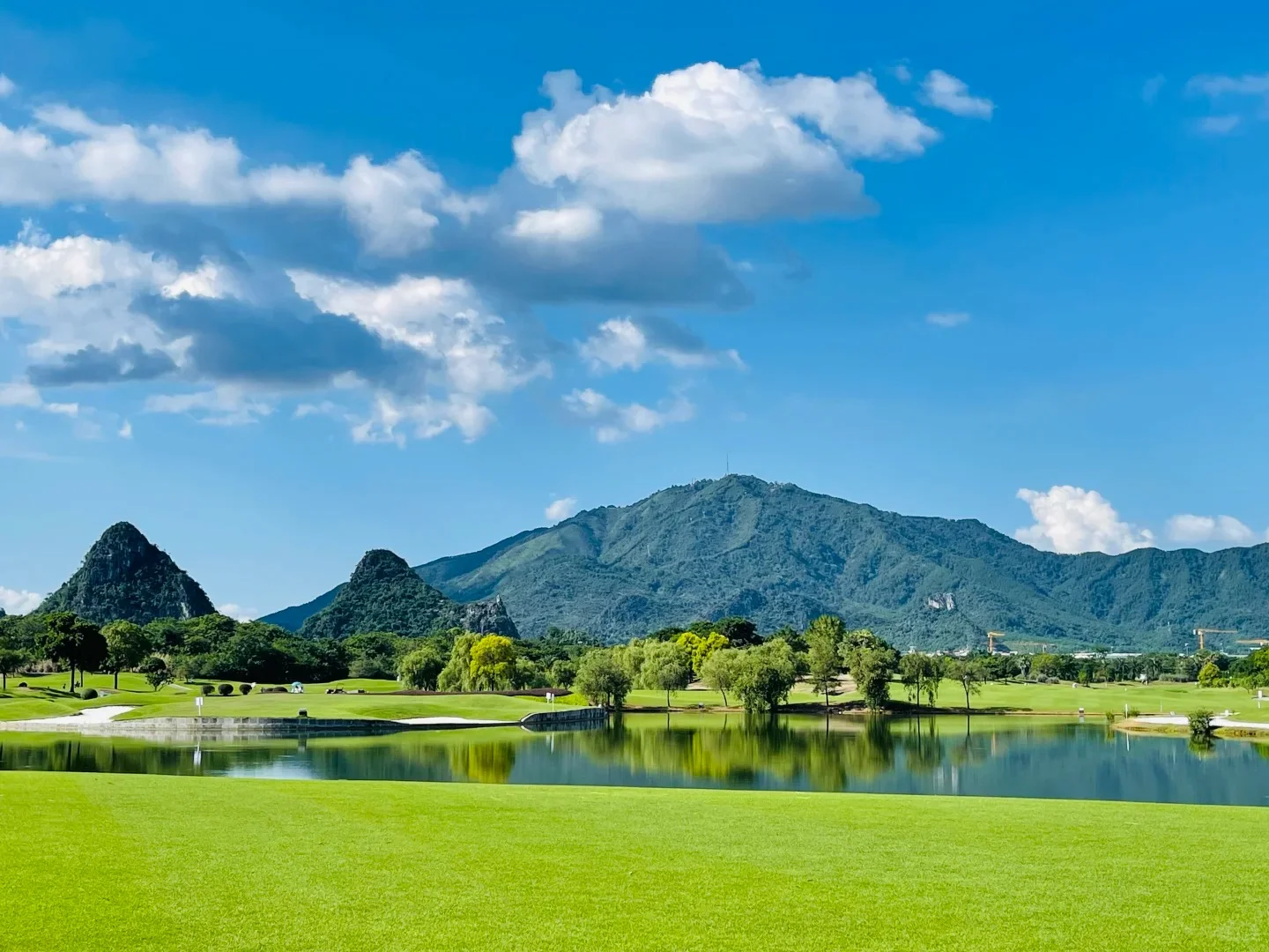 Karst peaks rising from a mirror lake at Guihai Qinglan park