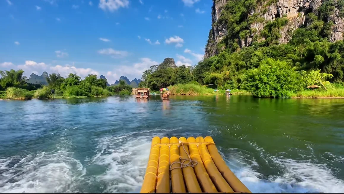 Bamboo raft on the Yulong River between karst mountains