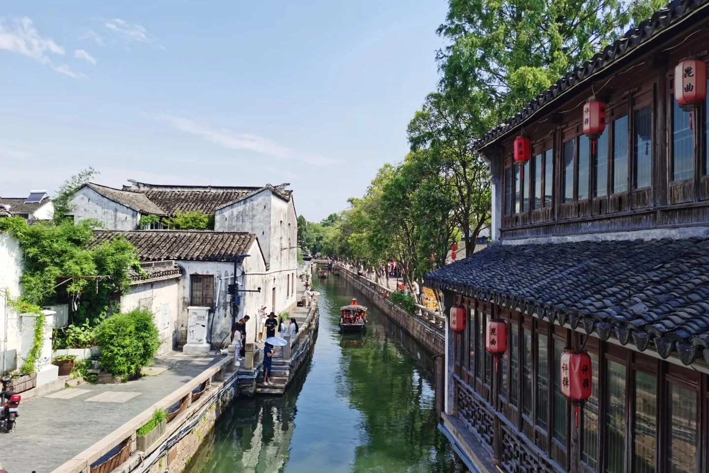 Pingjiang Road canal street in Suzhou old town with white-washed houses and stone bridges