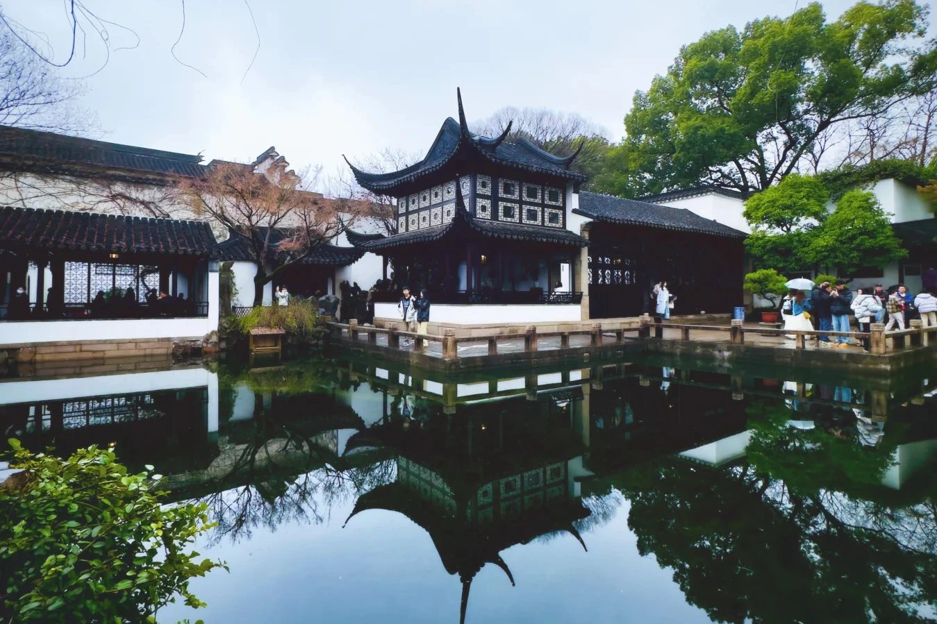 Lingering Garden waterside pavilion reflected in a calm pond with Taihu rockery