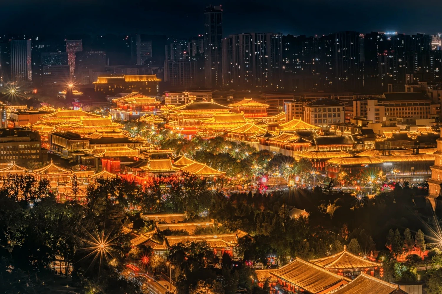 Grand Tang Mall at night — lanterns, Tang-style architecture and street performers along Xi'an's illuminated pedestrian street