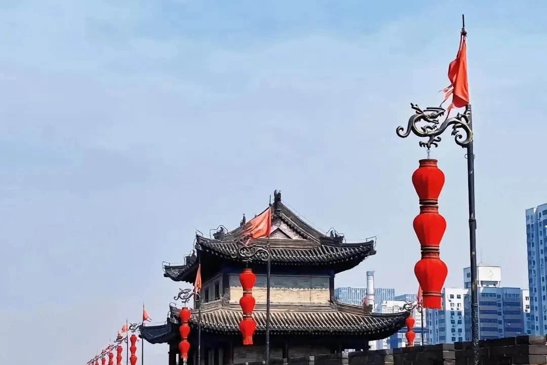 Xi'an ancient City Wall with watchtower and cyclists on top at golden hour